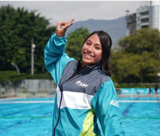 Mujer deportista de 19 años, teniendo de fondo una de las piscinas que hace parte de los escenarios INDER. 